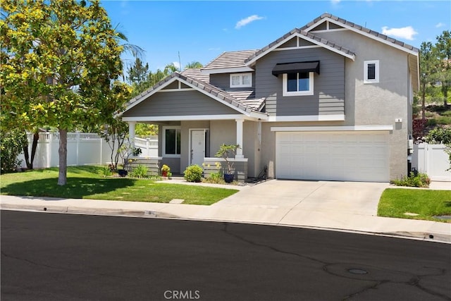 8 Chatri Cir, Lake Forest, CA 92610 - craftsman-style house featuring a tile roof, an attached garage, driveway, stucco siding, and covered porch