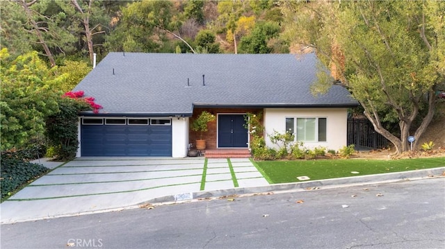 9767 Blantyre Dr, Beverly Hills, CA 90210 - view of front of property featuring a garage, driveway, a shingled roof, and a front yard