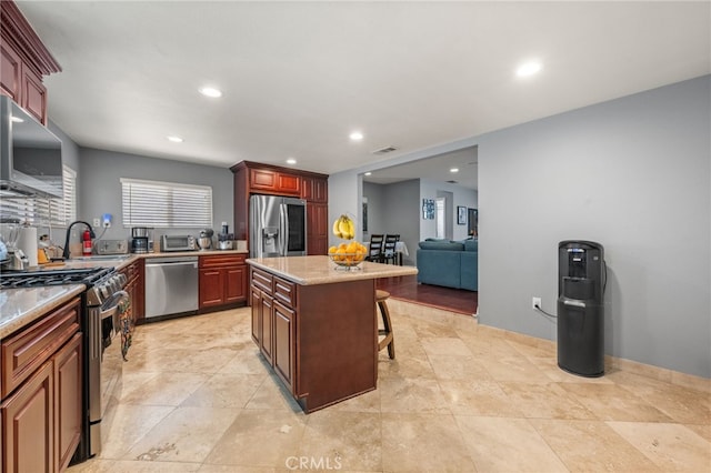 18091 Vine St, Fontana, CA 92335 - kitchen featuring appliances with stainless steel finishes, a breakfast bar, recessed lighting, a kitchen island, and open floor plan