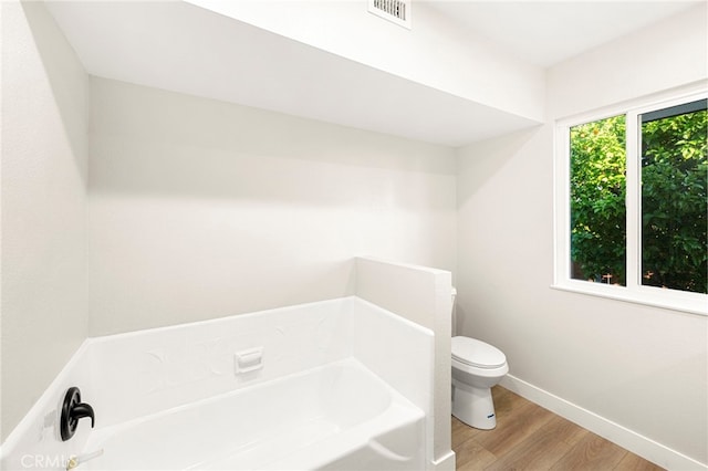 28610 Portsmouth Dr, Menifee, CA 92586 - bathroom featuring a bath and wood finished floors