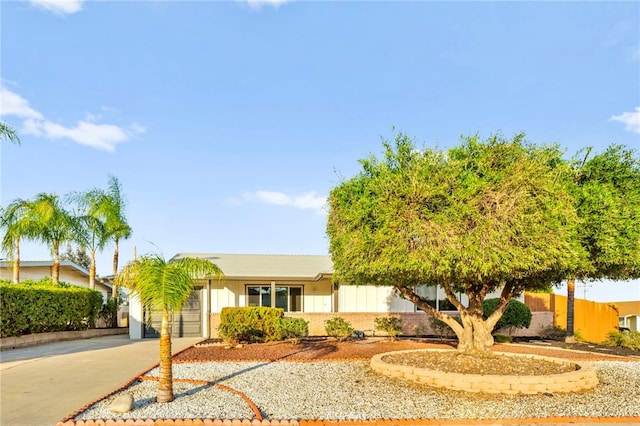 28610 Portsmouth Dr, Menifee, CA 92586 - view of front facade featuring driveway, a garage, and brick siding