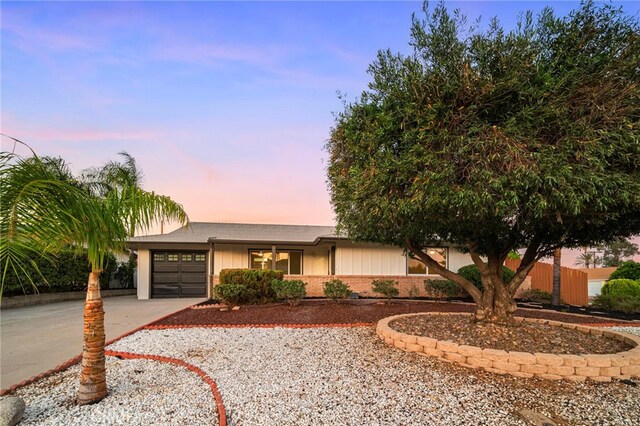 28610 Portsmouth Dr, Menifee, CA 92586 - ranch-style home with a garage, concrete driveway, brick siding, and board and batten siding