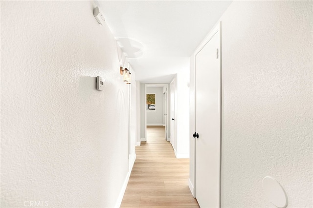 28610 Portsmouth Dr, Menifee, CA 92586 - corridor with light wood finished floors and a textured wall