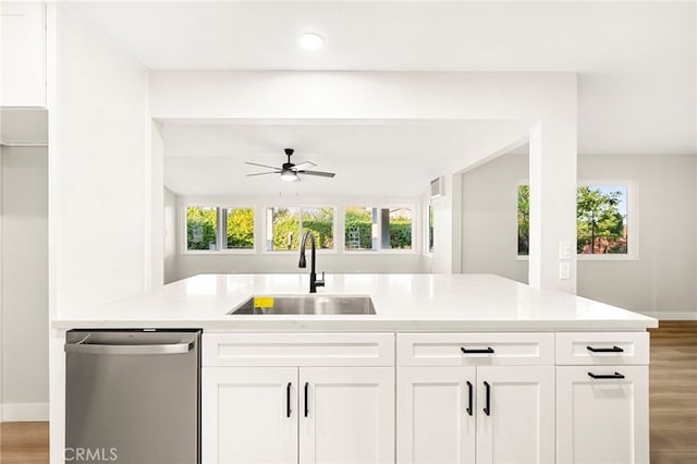 28610 Portsmouth Dr, Menifee, CA 92586 - kitchen with stainless steel dishwasher, ceiling fan, light wood-type flooring, white cabinets, and recessed lighting