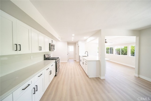 28610 Portsmouth Dr, Menifee, CA 92586 - kitchen with stainless steel appliances, light wood-style flooring, light countertops, and recessed lighting