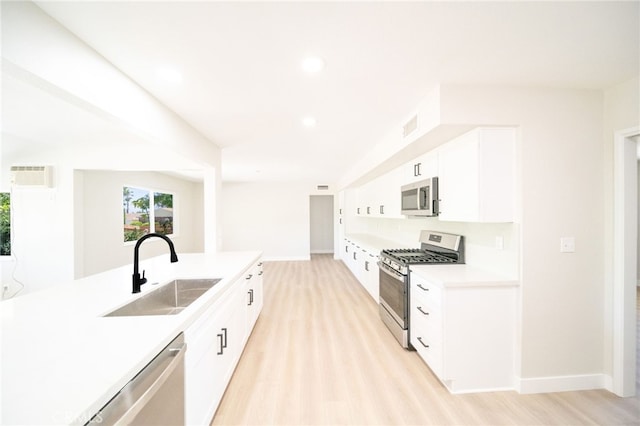 28610 Portsmouth Dr, Menifee, CA 92586 - kitchen featuring stainless steel appliances, white cabinets, light countertops, recessed lighting, and light wood-style flooring
