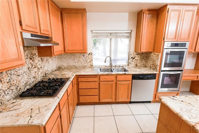 19385 Live Oak Ln, Lake Elsinore, CA 92530 - kitchen featuring appliances with stainless steel finishes, under cabinet range hood, decorative backsplash, light stone counters, and light tile patterned floors