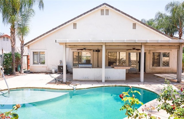 19385 Live Oak Ln, Lake Elsinore, CA 92530 - rear view of house featuring ceiling fan, a patio, stucco siding, and an outdoor pool