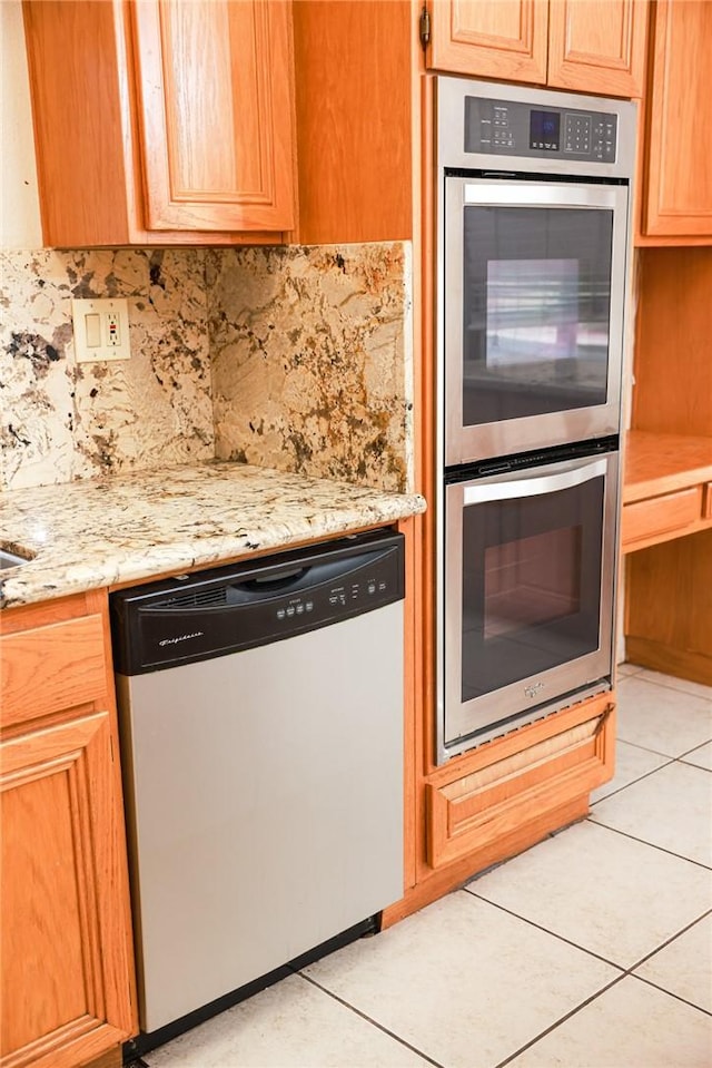 19385 Live Oak Ln, Lake Elsinore, CA 92530 - kitchen with stainless steel appliances, backsplash, light tile patterned floors, and light stone countertops