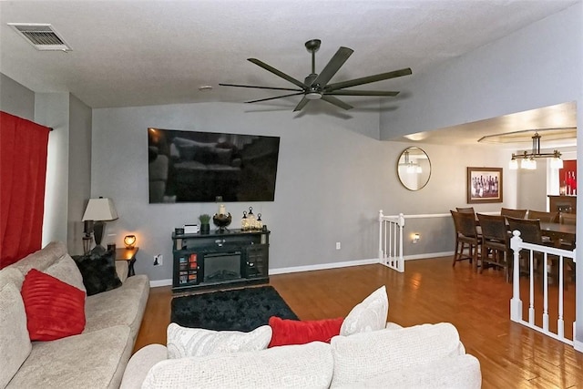 13665 Hidden Valley Rd, Victorville, CA 92395 - living area with wood finished floors, vaulted ceiling, a ceiling fan, and a chandelier