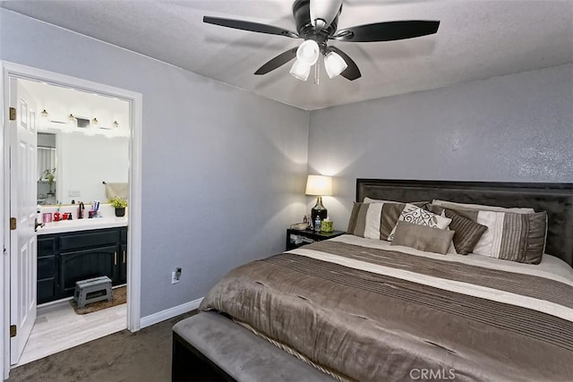 13665 Hidden Valley Rd, Victorville, CA 92395 - bedroom with ensuite bathroom, ceiling fan, and dark carpet