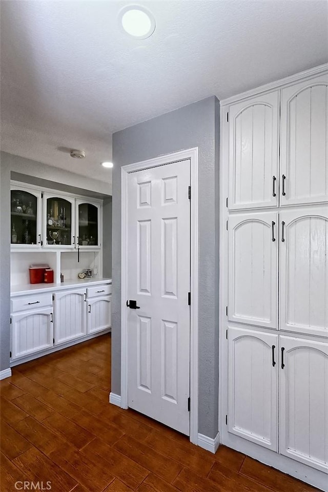 13665 Hidden Valley Rd, Victorville, CA 92395 - corridor featuring dark wood-type flooring and baseboards