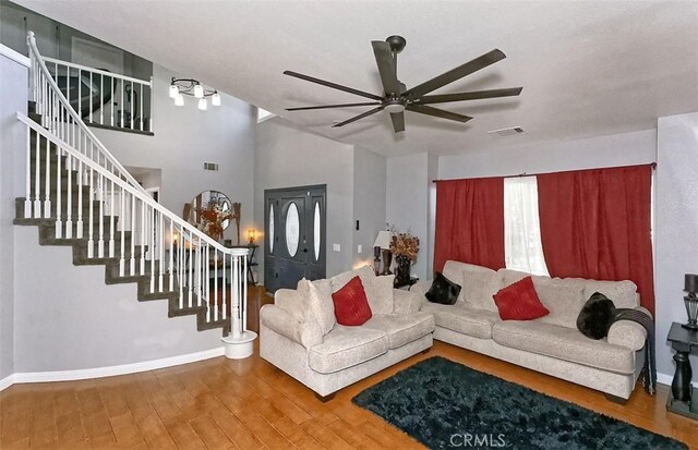 13665 Hidden Valley Rd, Victorville, CA 92395 - living room with a ceiling fan, stairway, wood finished floors, and lofted ceiling