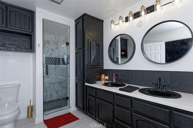 13665 Hidden Valley Rd, Victorville, CA 92395 - bathroom featuring a marble finish shower, tasteful backsplash, and double vanity