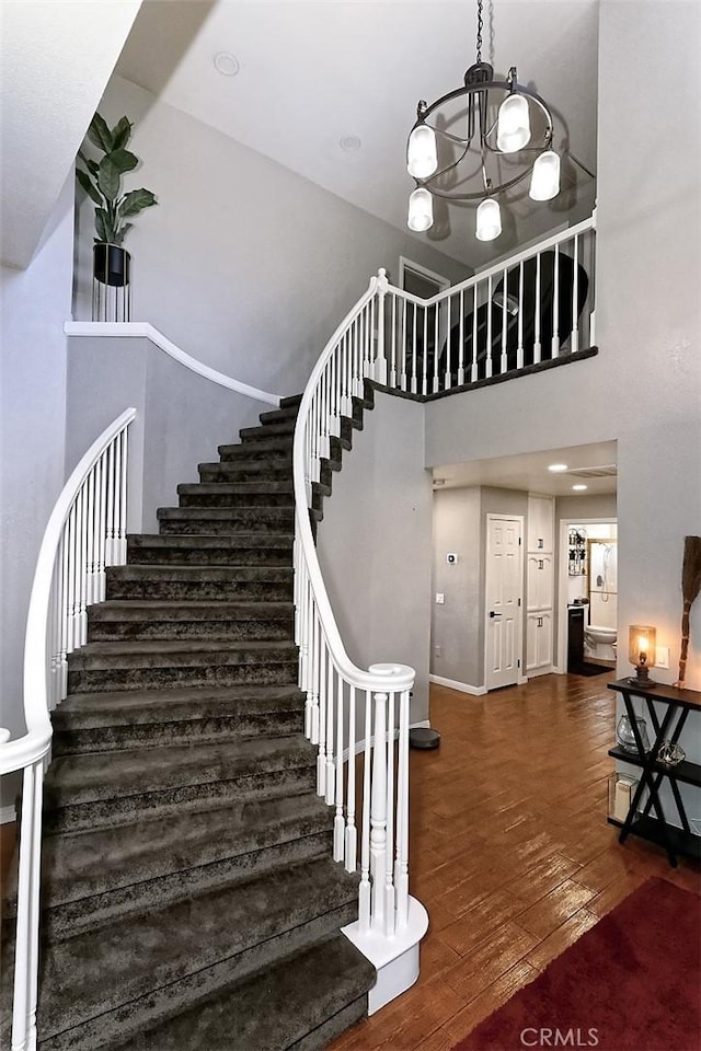 13665 Hidden Valley Rd, Victorville, CA 92395 - staircase with hardwood / wood-style flooring and a chandelier