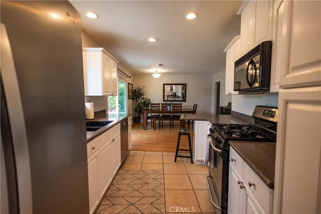 9025 La Vine St, Rancho Cucamonga, CA 91701 - kitchen with appliances with stainless steel finishes, dark countertops, white cabinetry, and recessed lighting