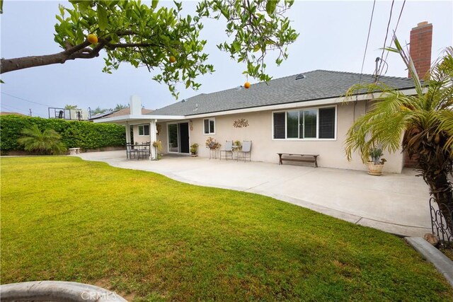 9025 La Vine St, Rancho Cucamonga, CA 91701 - back of property featuring stucco siding, a yard, a patio, a shingled roof, and a chimney