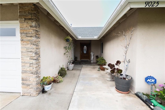 9025 La Vine St, Rancho Cucamonga, CA 91701 - property entrance featuring stucco siding, stone siding, roof with shingles, and a garage