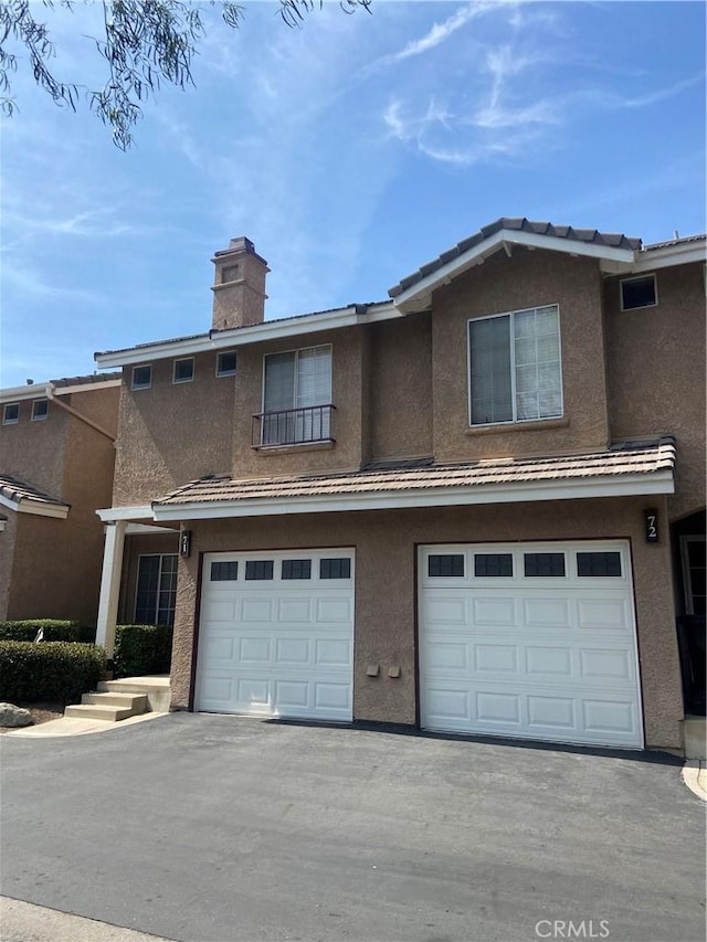 11254 Terra Vista Pkwy Unit 71, Rancho Cucamonga, CA 91730 - view of front of property featuring a garage, driveway, and stucco siding