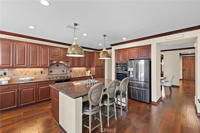 14 Downing St, Ladera Ranch, CA 92694 - kitchen with stainless steel appliances, crown molding, decorative backsplash, recessed lighting, and dark stone countertops