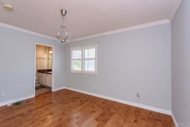 17159 W Bernardo Dr Unit 202, San Diego, CA 92127 - spare room with a chandelier, crown molding, light wood-type flooring, and a smoke detector