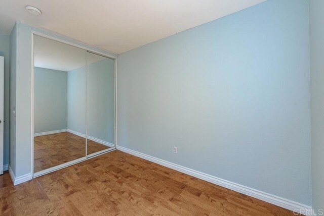 17159 W Bernardo Dr Unit 202, San Diego, CA 92127 - unfurnished bedroom featuring a closet and wood finished floors