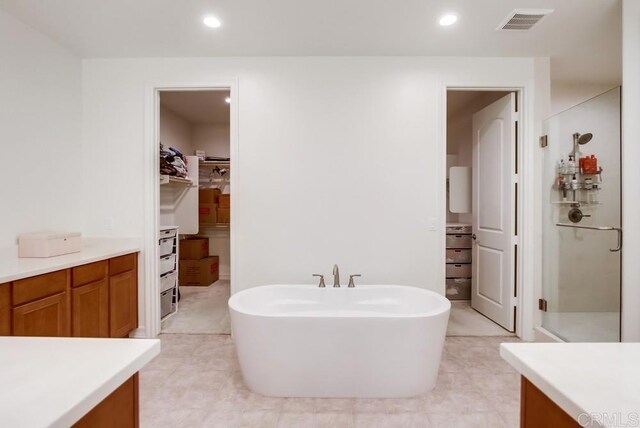 1873 El Paseo Ave, Chula Vista, CA 91913 - bathroom featuring a spacious closet, a soaking tub, recessed lighting, a stall shower, and vanity