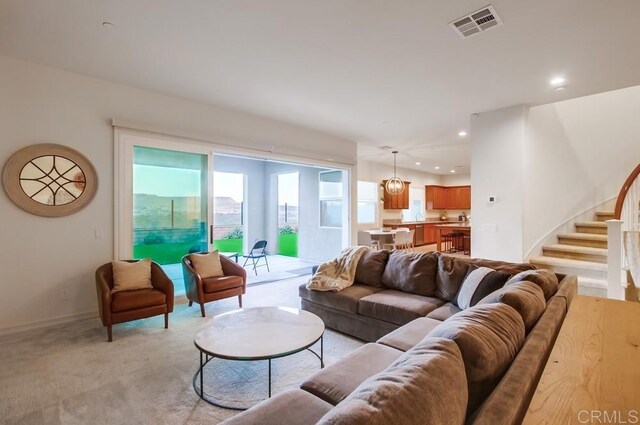 1873 El Paseo Ave, Chula Vista, CA 91913 - living area featuring light carpet, stairs, and recessed lighting