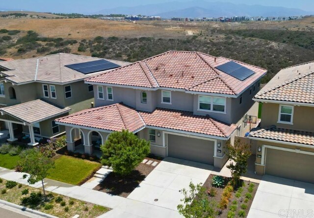 1873 El Paseo Ave, Chula Vista, CA 91913 - view of front facade featuring driveway, a tile roof, stucco siding, a garage, and a porch