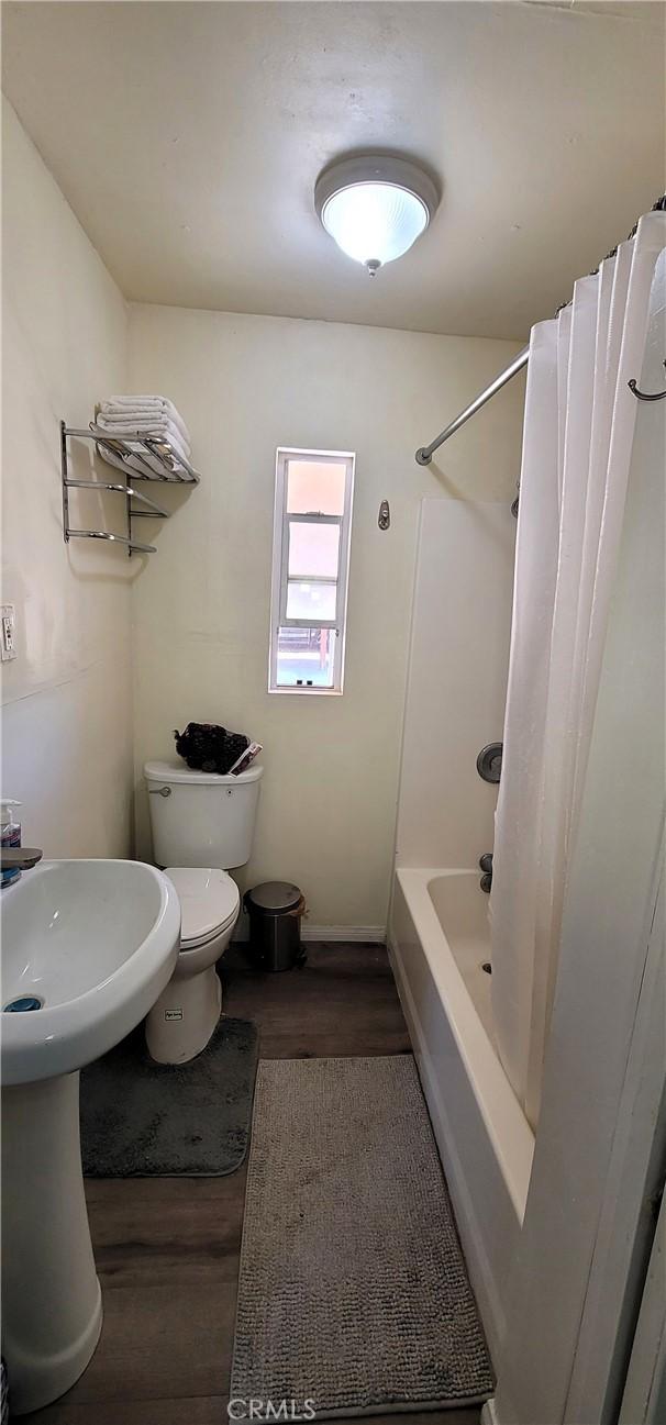 12101 Kern Ave, Boron, CA 93516 - bathroom featuring wood finished floors and shower / bathtub combination with curtain