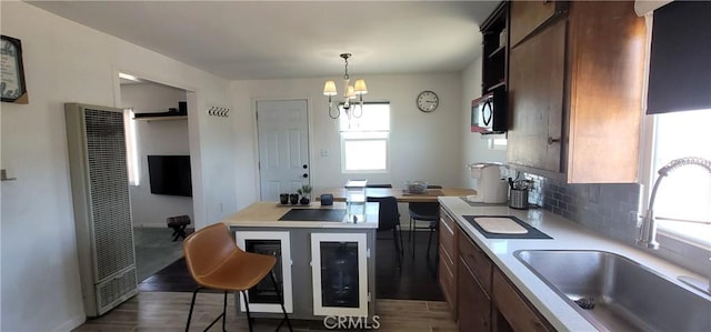 12101 Kern Ave, Boron, CA 93516 - kitchen featuring a heating unit, dark wood-style floors, a chandelier, and light countertops