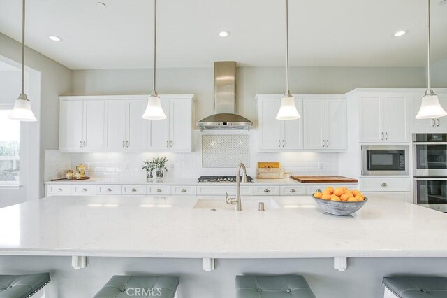 916 Trail View Pl, Nipomo, CA 93444 - kitchen featuring wall chimney exhaust hood, black microwave, double oven, backsplash, and white cabinets