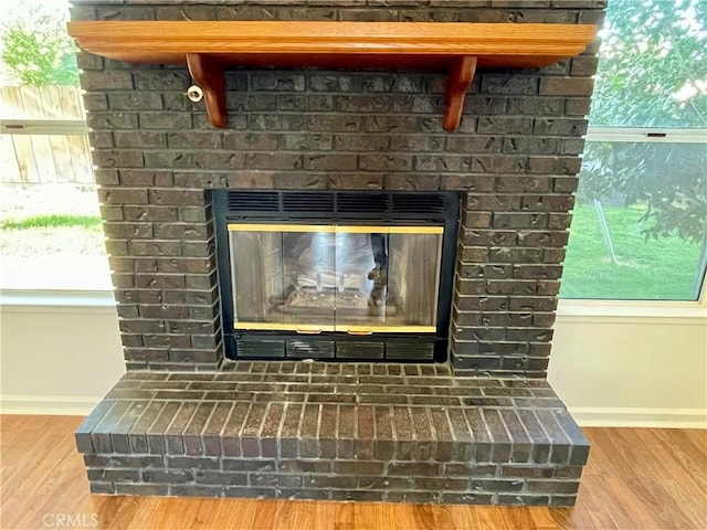 659 Royal Arch Ct, Merced, CA 95340 - detailed view of a brick fireplace and wood finished floors