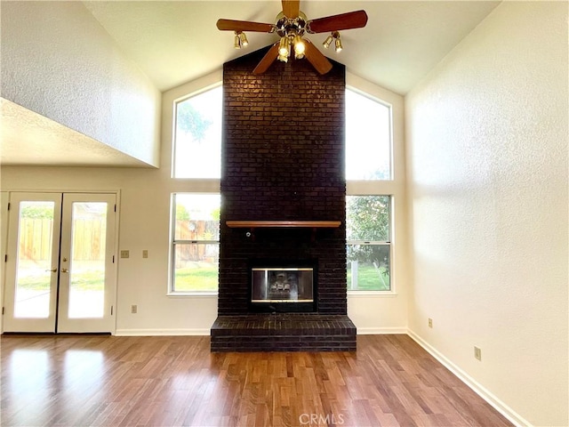 659 Royal Arch Ct, Merced, CA 95340 - unfurnished living room with wood finished floors, a ceiling fan, high vaulted ceiling, and a fireplace