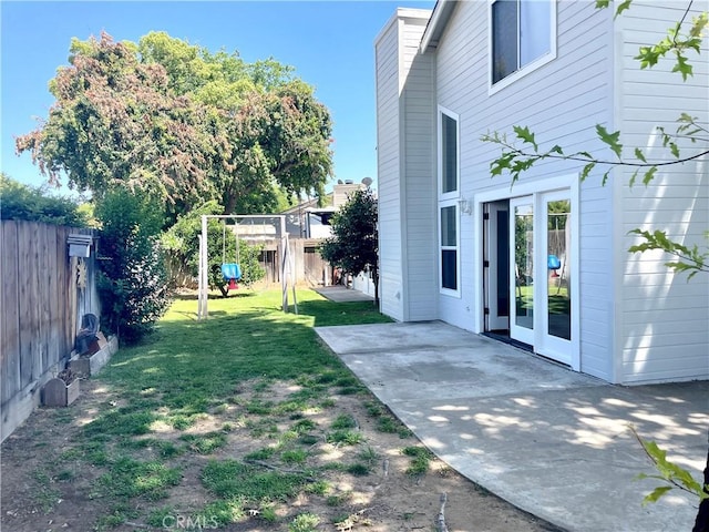 659 Royal Arch Ct, Merced, CA 95340 - fenced backyard featuring a patio and a playground