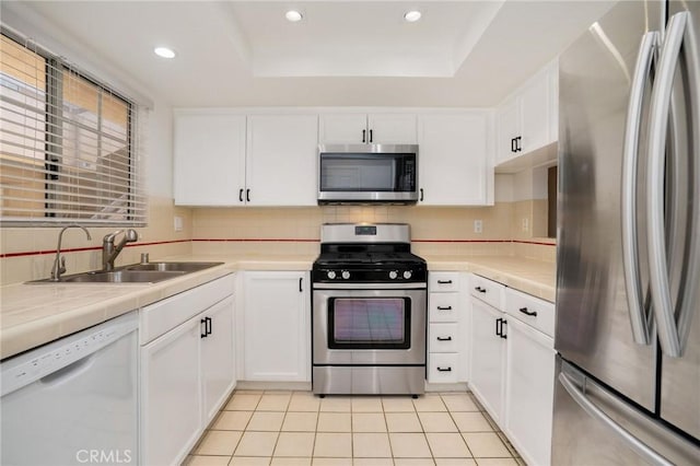 333 W Alameda Ave Unit 208, Burbank, CA 91506 - kitchen with stainless steel appliances, white cabinetry, a raised ceiling, tile counters, and recessed lighting