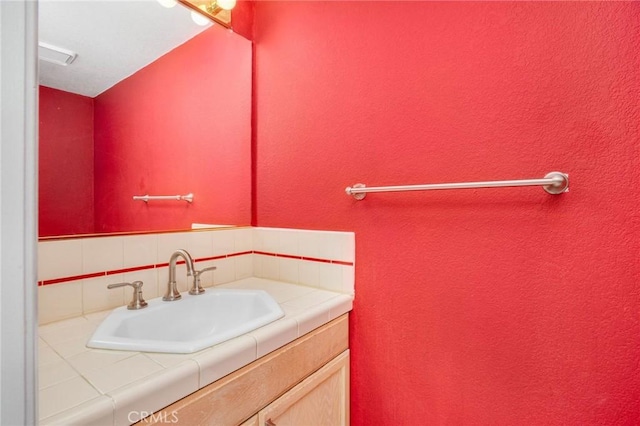 333 W Alameda Ave Unit 208, Burbank, CA 91506 - bathroom featuring vanity, tasteful backsplash, and a textured wall