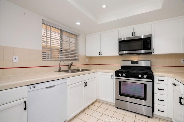 333 W Alameda Ave Unit 208, Burbank, CA 91506 - kitchen featuring appliances with stainless steel finishes, white cabinets, decorative backsplash, recessed lighting, and tile counters