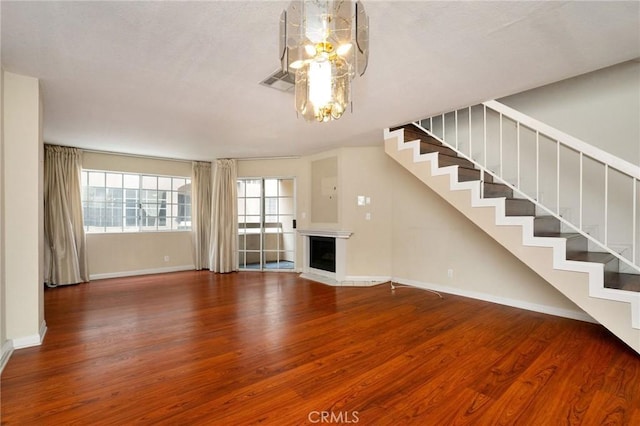 333 W Alameda Ave Unit 208, Burbank, CA 91506 - unfurnished living room with a chandelier, wood finished floors, stairs, and a fireplace