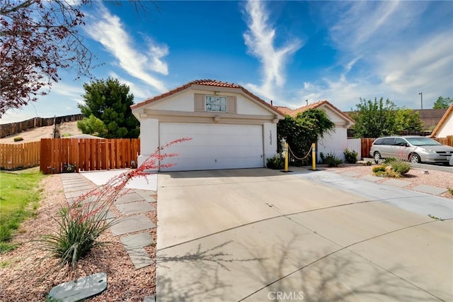 13035 Troy Ct, Victorville, CA 92395 - view of front facade with concrete driveway, stucco siding, and a tile roof