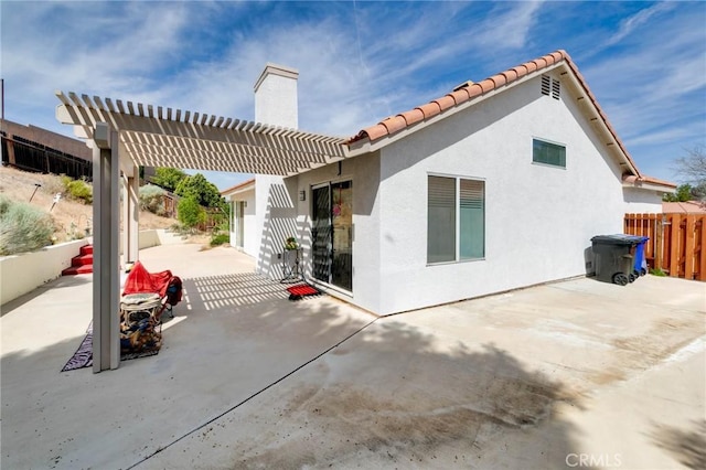 13035 Troy Ct, Victorville, CA 92395 - rear view of property with a patio area, a chimney, a pergola, stucco siding, and a tiled roof