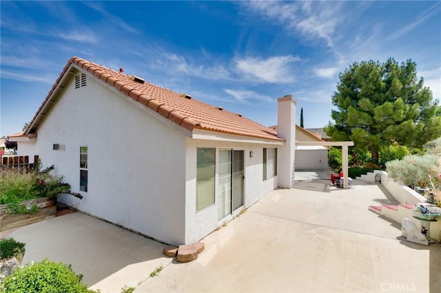 13035 Troy Ct, Victorville, CA 92395 - rear view of house with a patio area, stucco siding, and a tiled roof