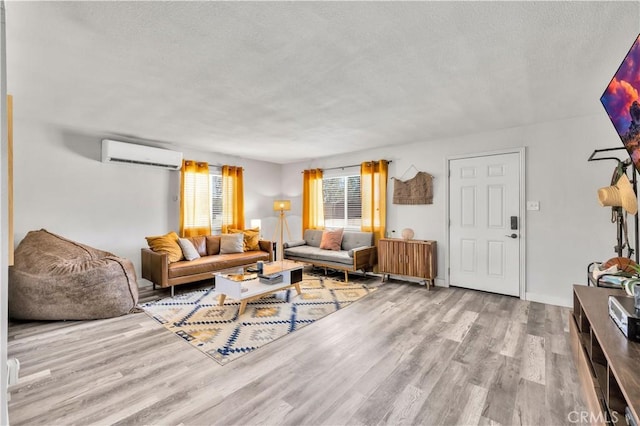 56565 Antelope Trl, Yucca Valley, CA 92284 - living area with a wall mounted air conditioner, wood finished floors, and a textured ceiling