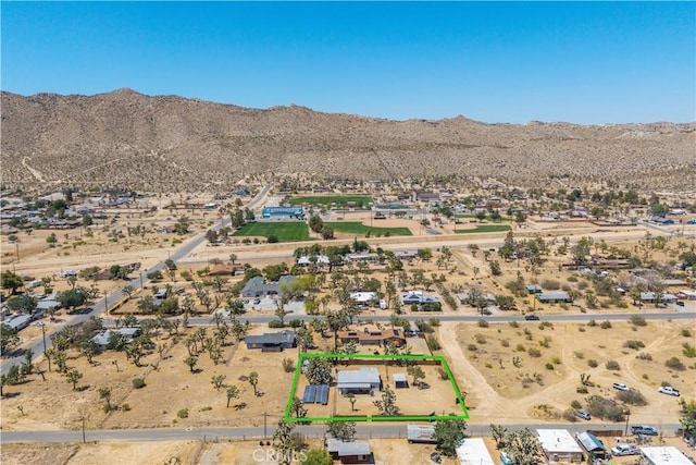 56565 Antelope Trl, Yucca Valley, CA 92284 - aerial view of sparsely populated area with a mountain backdrop and property parcel outlined