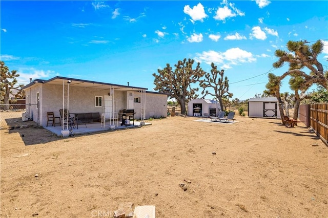 56565 Antelope Trl, Yucca Valley, CA 92284 - rear view of property with a patio, a storage shed, stucco siding, and a fenced backyard