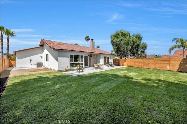 25652 Cervantes Ln, Mission Viejo, CA 92691 - back of property with a fenced backyard, a tile roof, a chimney, stucco siding, and a patio