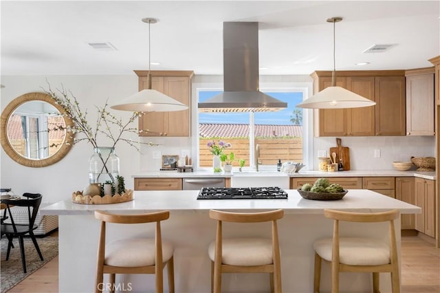 25652 Cervantes Ln, Mission Viejo, CA 92691 - kitchen with island exhaust hood, stainless steel appliances, light wood-type flooring, light countertops, and recessed lighting