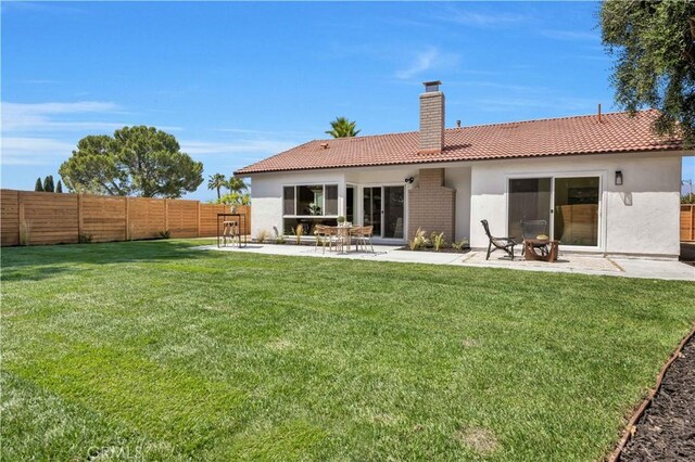 25652 Cervantes Ln, Mission Viejo, CA 92691 - back of house featuring a tile roof, a chimney, stucco siding, and a patio area