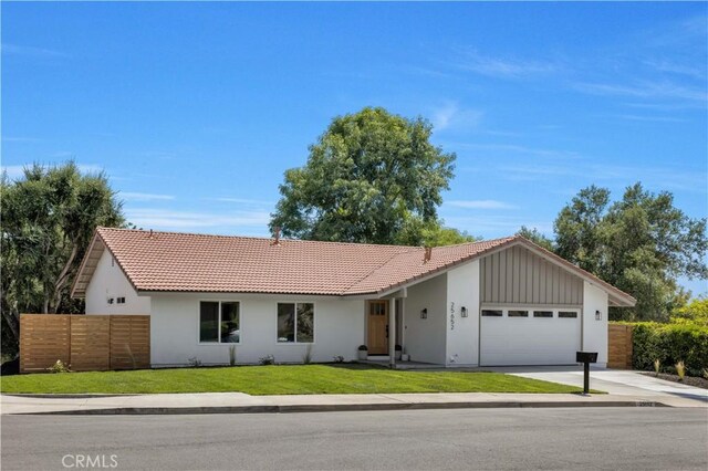 25652 Cervantes Ln, Mission Viejo, CA 92691 - ranch-style house with a tile roof, a garage, concrete driveway, and stucco siding