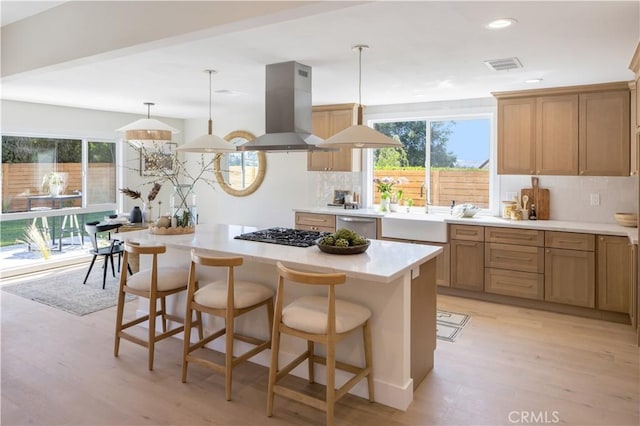 25652 Cervantes Ln, Mission Viejo, CA 92691 - kitchen featuring island exhaust hood, black gas stovetop, dishwasher, decorative backsplash, and recessed lighting